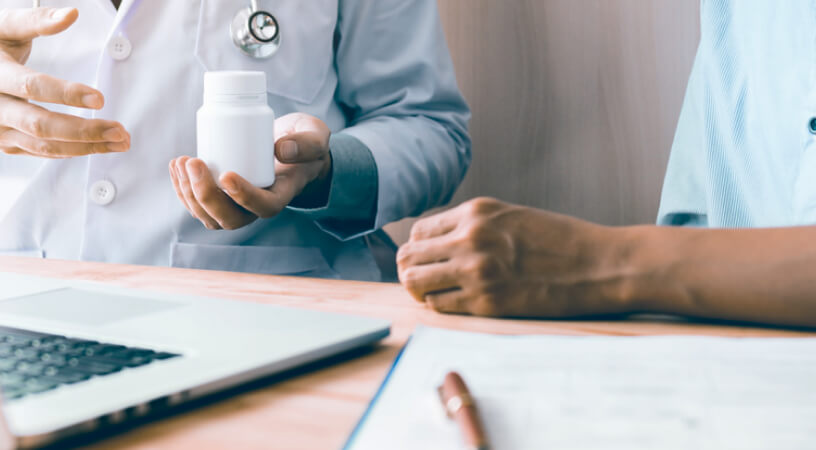 Doctor man discussing supplement quality and medical documents with his patient